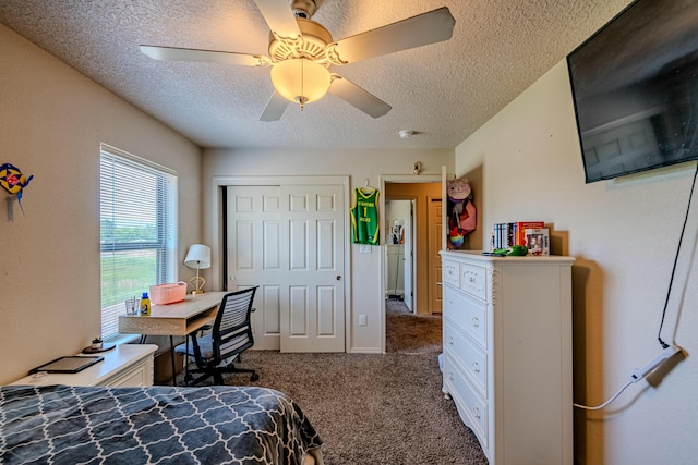 bedroom featuring a closet, ceiling fan, dark carpet, and a textured ceiling