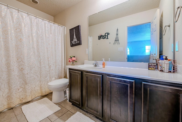 bathroom with vanity, tile patterned floors, toilet, and a textured ceiling