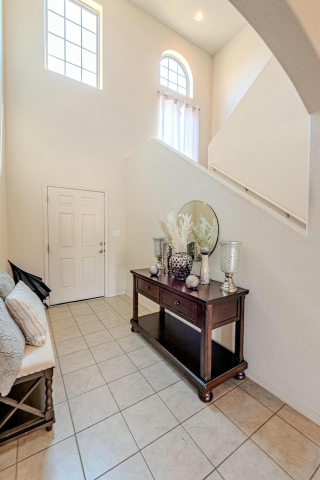 tiled foyer entrance featuring a high ceiling