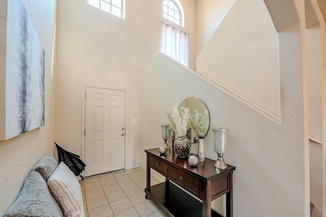 tiled entrance foyer featuring a high ceiling