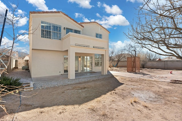 back of property with a patio