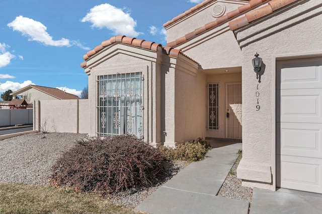 view of exterior entry with a garage