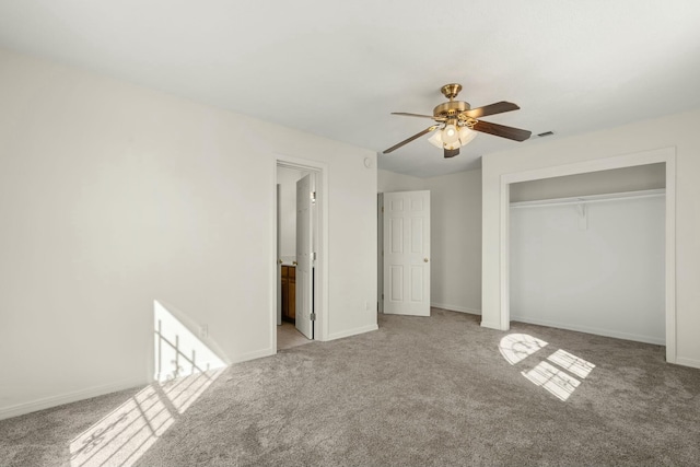 unfurnished bedroom featuring connected bathroom, light colored carpet, ceiling fan, and a closet