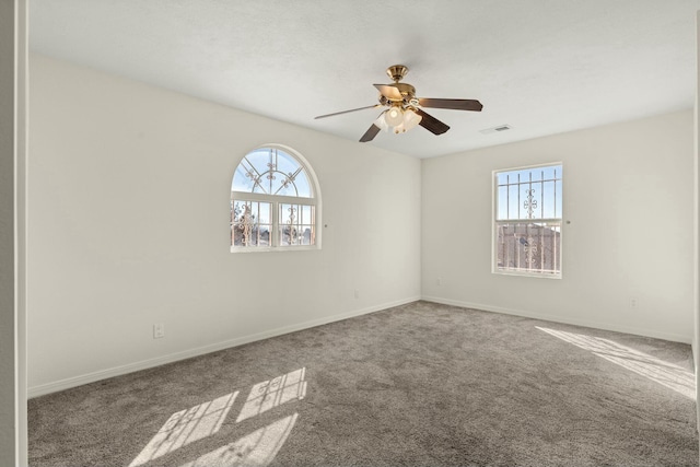 empty room featuring ceiling fan and carpet floors