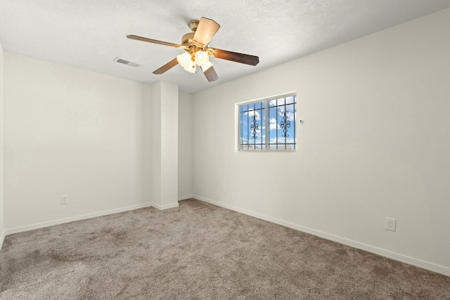 unfurnished room with ceiling fan, carpet flooring, and a textured ceiling