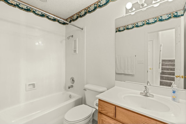 full bathroom with shower / bath combination, vanity, a textured ceiling, and toilet