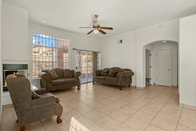 living room featuring light tile patterned flooring and ceiling fan