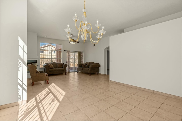 tiled living room with a notable chandelier