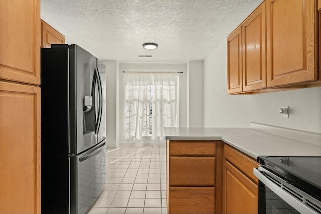 kitchen with stainless steel refrigerator with ice dispenser, light tile patterned flooring, a textured ceiling, and kitchen peninsula