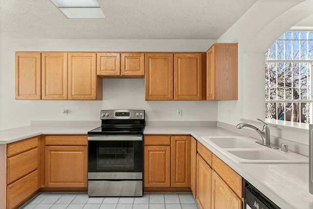 kitchen featuring light tile patterned flooring, sink, a textured ceiling, electric range, and dishwasher