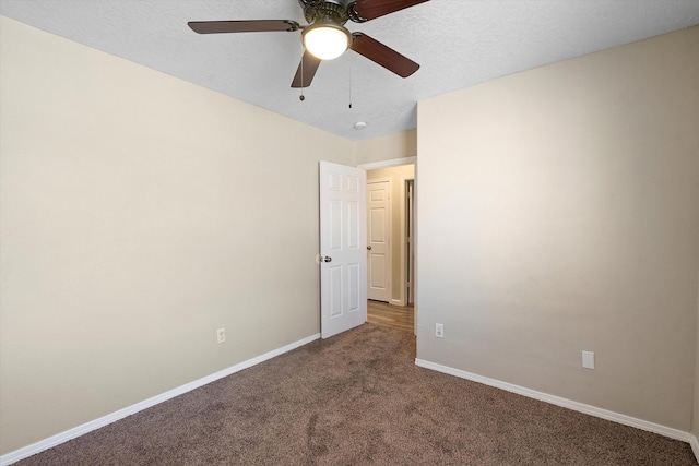 spare room featuring carpet floors and a textured ceiling