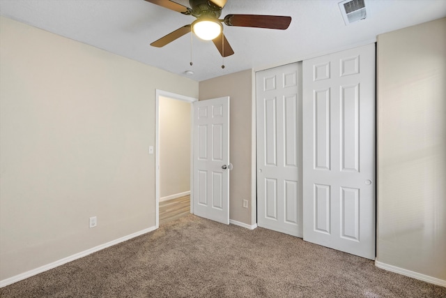 unfurnished bedroom with light carpet, ceiling fan, and a closet