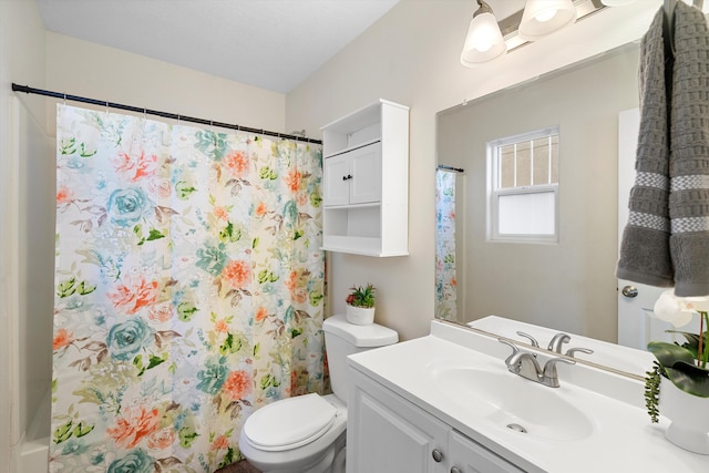 bathroom with walk in shower, vanity, and toilet