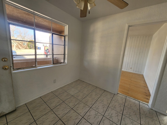 unfurnished room with ceiling fan