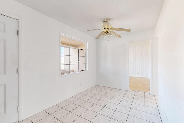 tiled spare room with ceiling fan