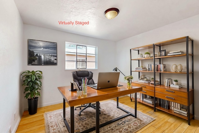 office area with light hardwood / wood-style flooring