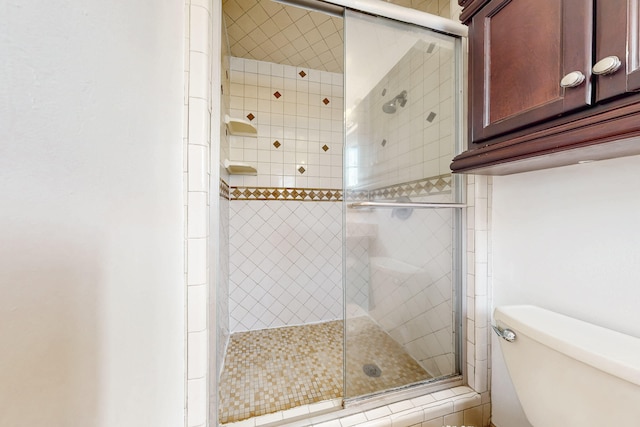 bathroom with walk in shower and toilet