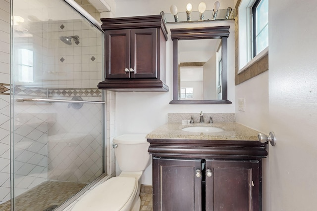 bathroom with vanity, toilet, and an enclosed shower