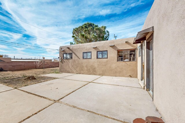 view of property exterior with a patio