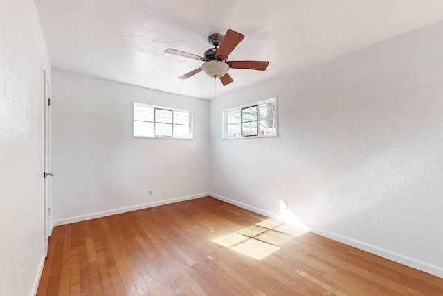 empty room with hardwood / wood-style flooring and ceiling fan