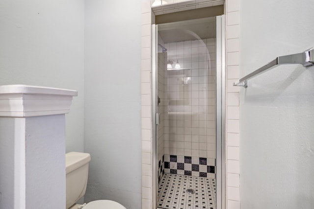 bathroom featuring walk in shower and toilet