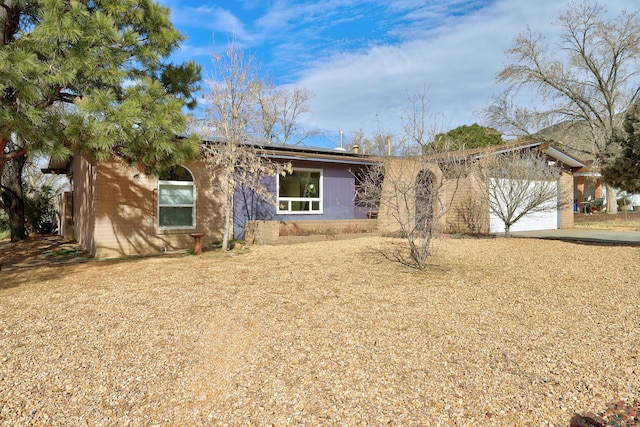 ranch-style home featuring a garage