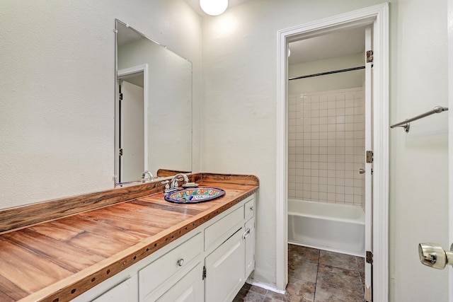 bathroom with vanity and tiled shower / bath combo