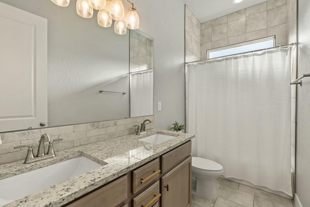 full bathroom featuring vanity, shower / bath combination with curtain, tile patterned floors, and toilet