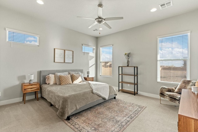 bedroom with ceiling fan and light carpet