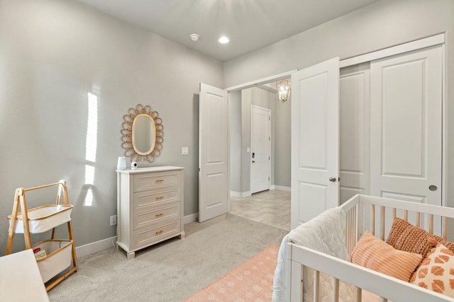 bedroom with light carpet and a closet