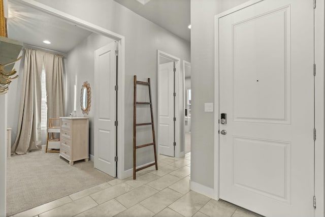 foyer entrance with light colored carpet