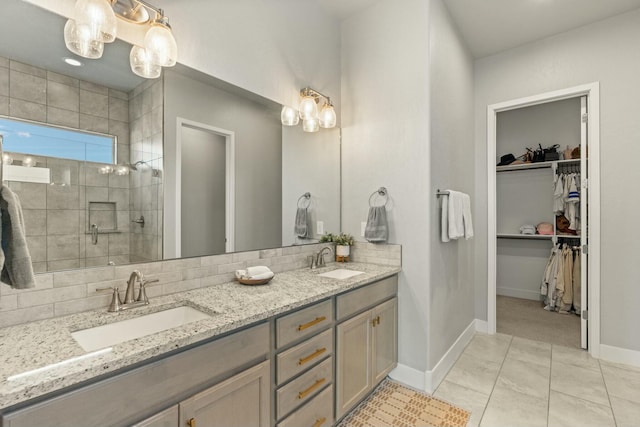 bathroom with vanity, backsplash, a shower with shower door, and tile patterned floors