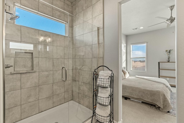 bathroom with a shower with door and ceiling fan