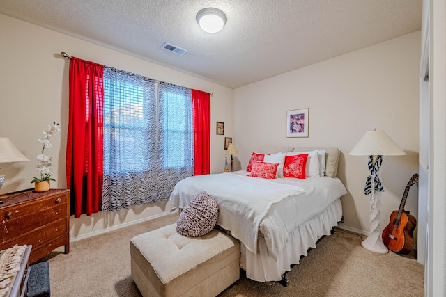 carpeted bedroom featuring a textured ceiling