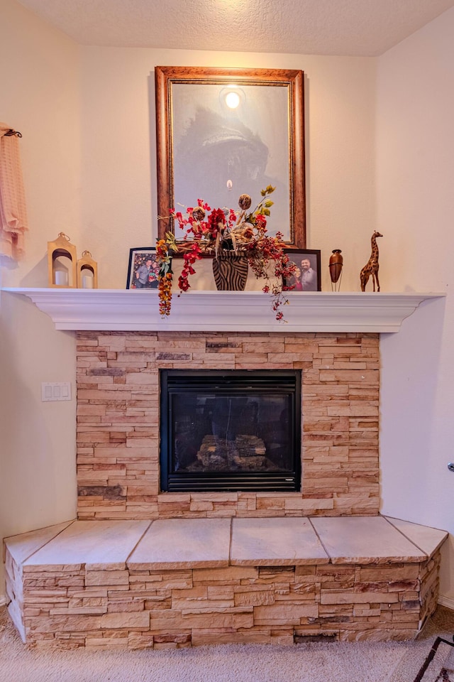 details with a stone fireplace and a textured ceiling