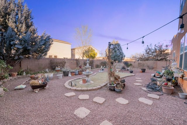 view of yard at dusk