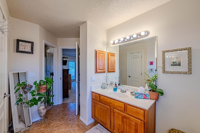 bathroom with vanity, tile patterned floors, and a textured ceiling