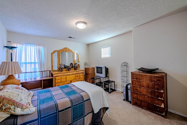 bedroom featuring a textured ceiling and carpet flooring