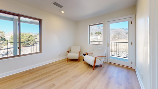 living area with a healthy amount of sunlight and light wood-type flooring