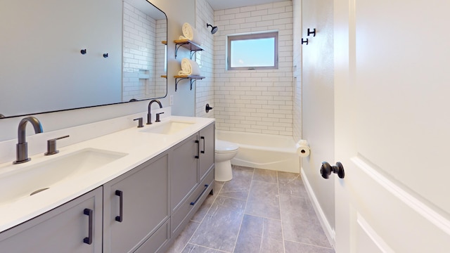 full bathroom featuring vanity, tiled shower / bath, tile patterned floors, and toilet