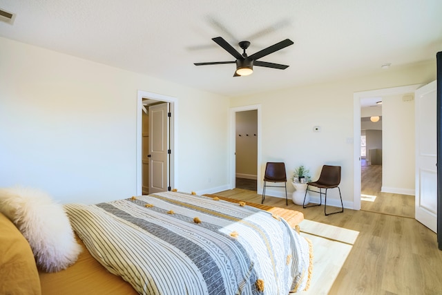 bedroom with ceiling fan and light hardwood / wood-style flooring