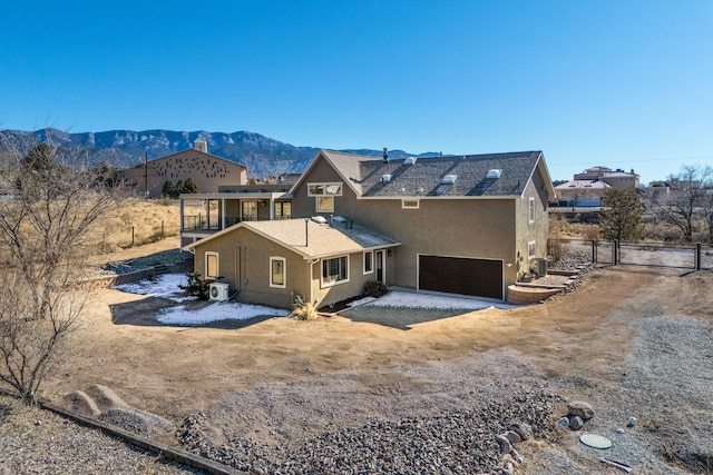 back of property featuring a garage and a mountain view