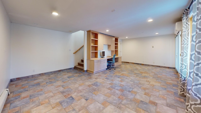 basement with a wall mounted AC and baseboard heating