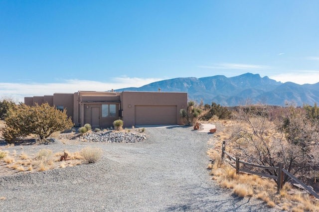 view of front of property with a garage and a mountain view