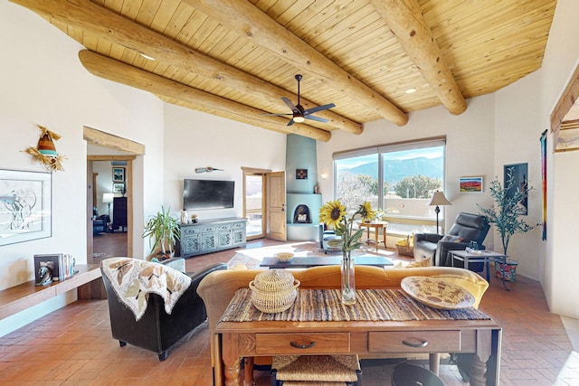 living room with a high ceiling, ceiling fan, wooden ceiling, and beam ceiling