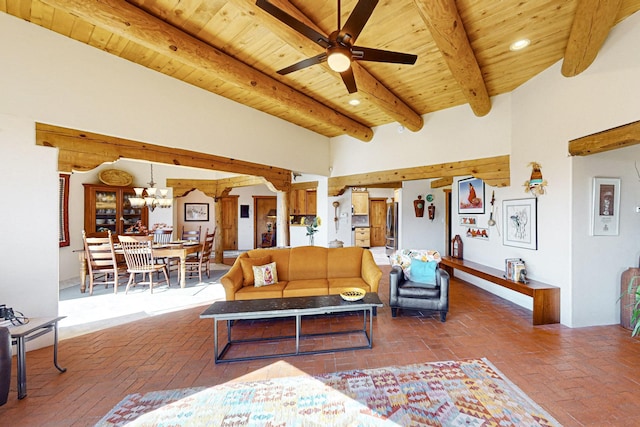 living room with beamed ceiling, ceiling fan with notable chandelier, and wooden ceiling