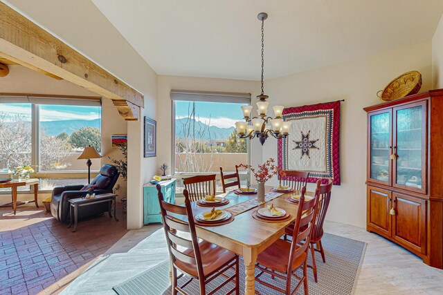 dining area featuring plenty of natural light, a chandelier, and a mountain view