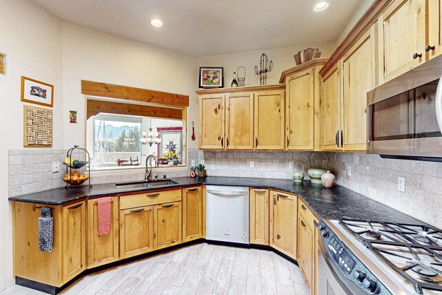 kitchen featuring stainless steel appliances, tasteful backsplash, and sink