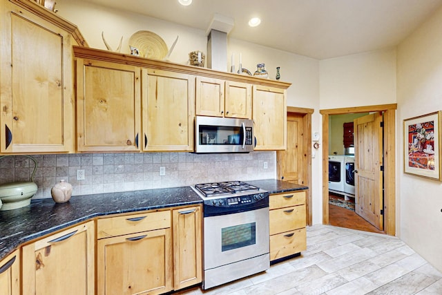 kitchen with tasteful backsplash, stainless steel appliances, washer and dryer, and light brown cabinets