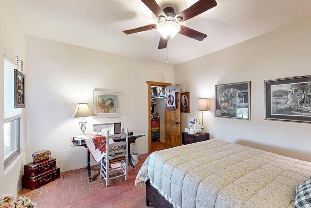 bedroom with a spacious closet, a closet, and ceiling fan